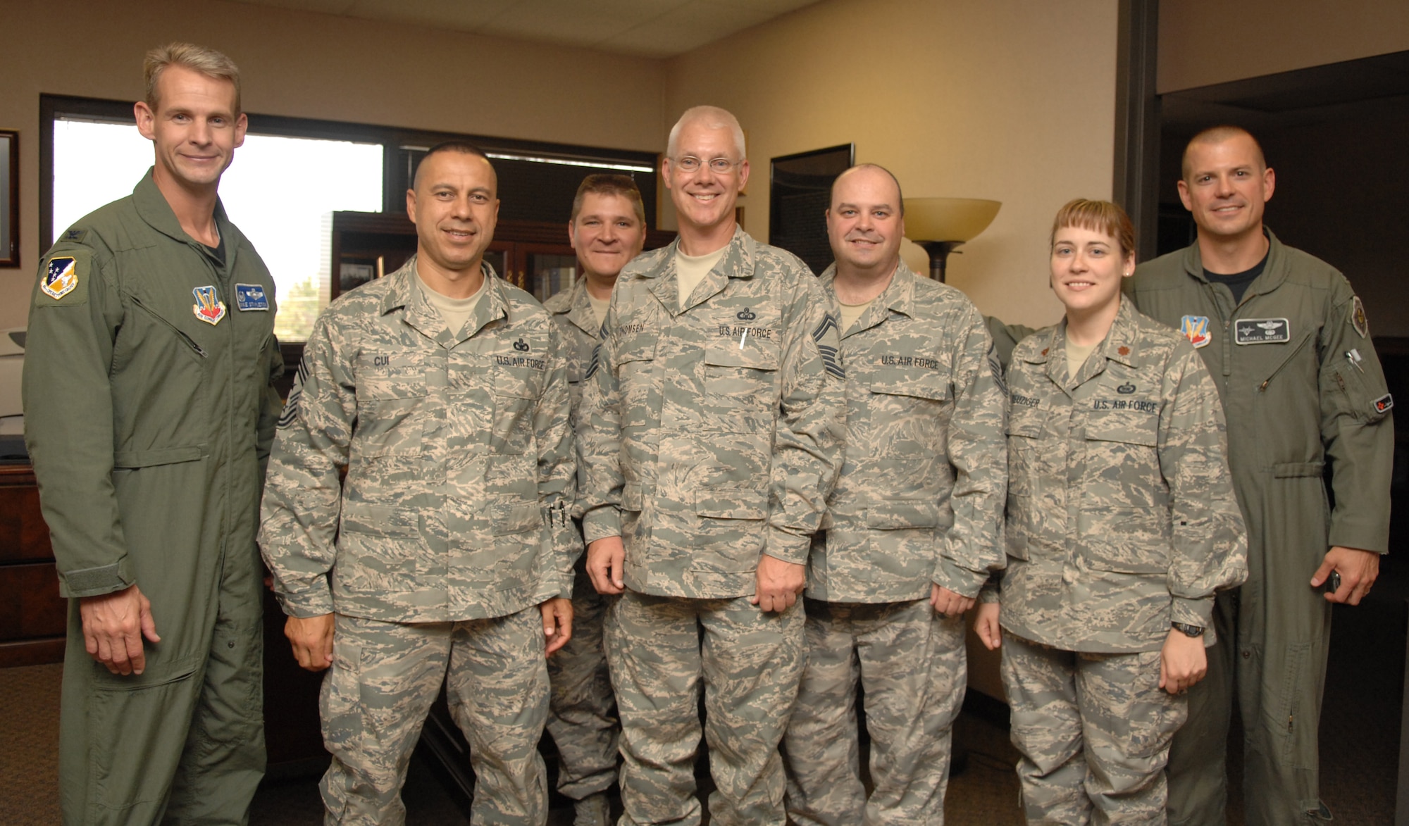 Senior Master Sgt. Scott Thomsen from the 49th Operation Support Squadron returned home to Holloman Air Force Base, N.M., July 30, from a six-month deployment to Iraq. After greeting the returning warrior, everyone posed for a photograph. From left to right: Col. Michael Stapleton, 49th Operations Group commander, Command Chief Master Sgt. Jeffrey Cui, 49th Fighter Wing command chief, Chief Master Sgt. William Urick, 49 OG superintendant, Sergeant Thomsen, the returning warrior, Master Sgt. Paul Connelly, 49 OSS first sergeant, Maj. Stacy Kreuziger, 49 OSS Intelligence Flight commander and Col. Michael Magee, 49 FW vice commander. (U.S. Air Force photo/Airman Sondra M. Wieseler)