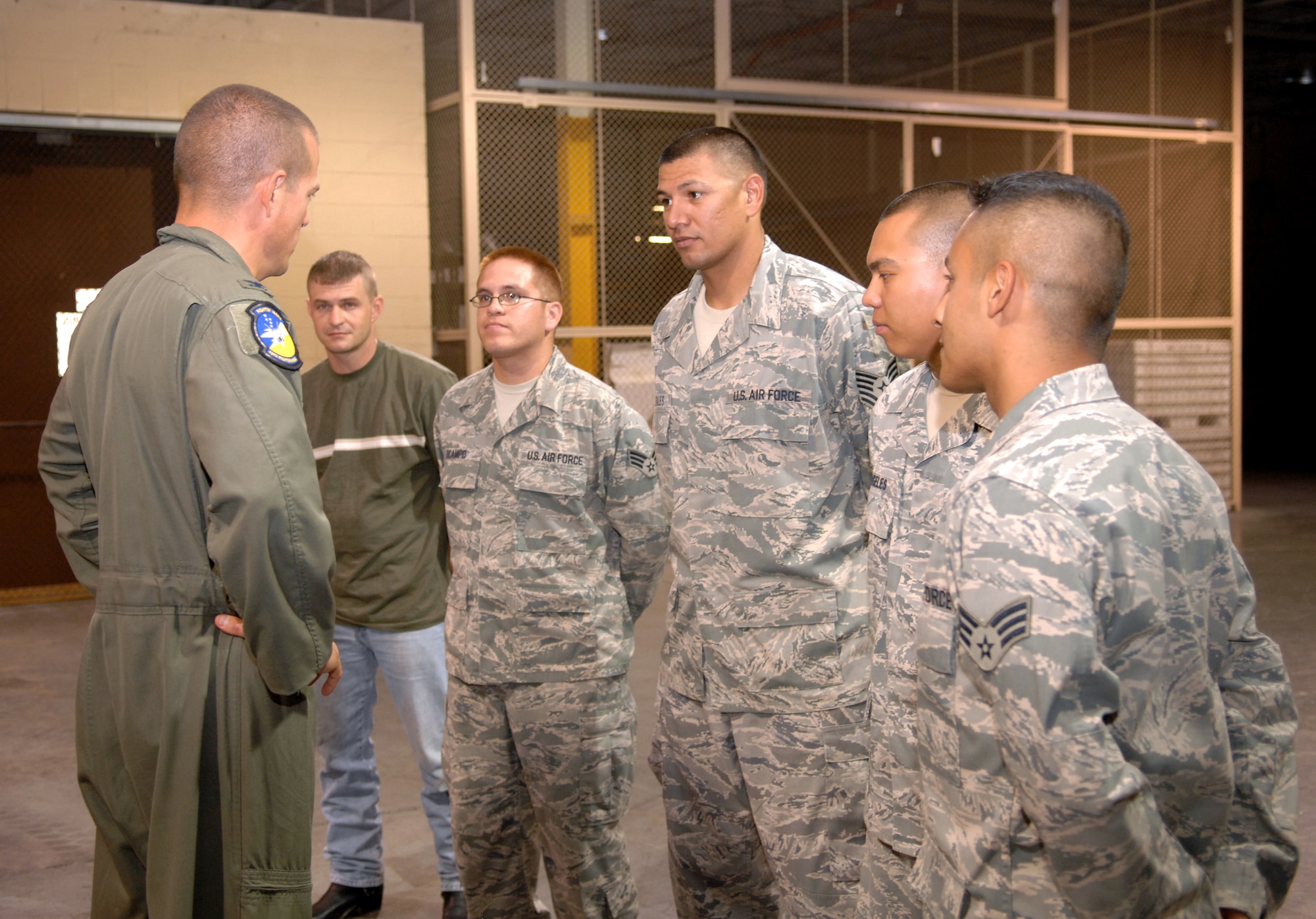 Col. Michael Magee, 49th Fighter Wing vice commander, speaks to all of the returning warriors at the armory at Holloman Air Force Base, N.M., July 25. The Airmen from left to right include; Staff Sgt. Johnnie Clevenger, 49th Materiel Maintenance Support Squadron, Senior Airman Thomas OCampo, Tech. Sgt. Alfredo Gonzales, Airman 1st Class Narciso Angeles and Senior Airman Mario Garcia, all from the 49th Logistics Readiness Squadron. The Airmen were deployed for various lengths of time and to different areas in Iraq. (U.S. Air Force photo/Airman Sondra M. Wieseler)