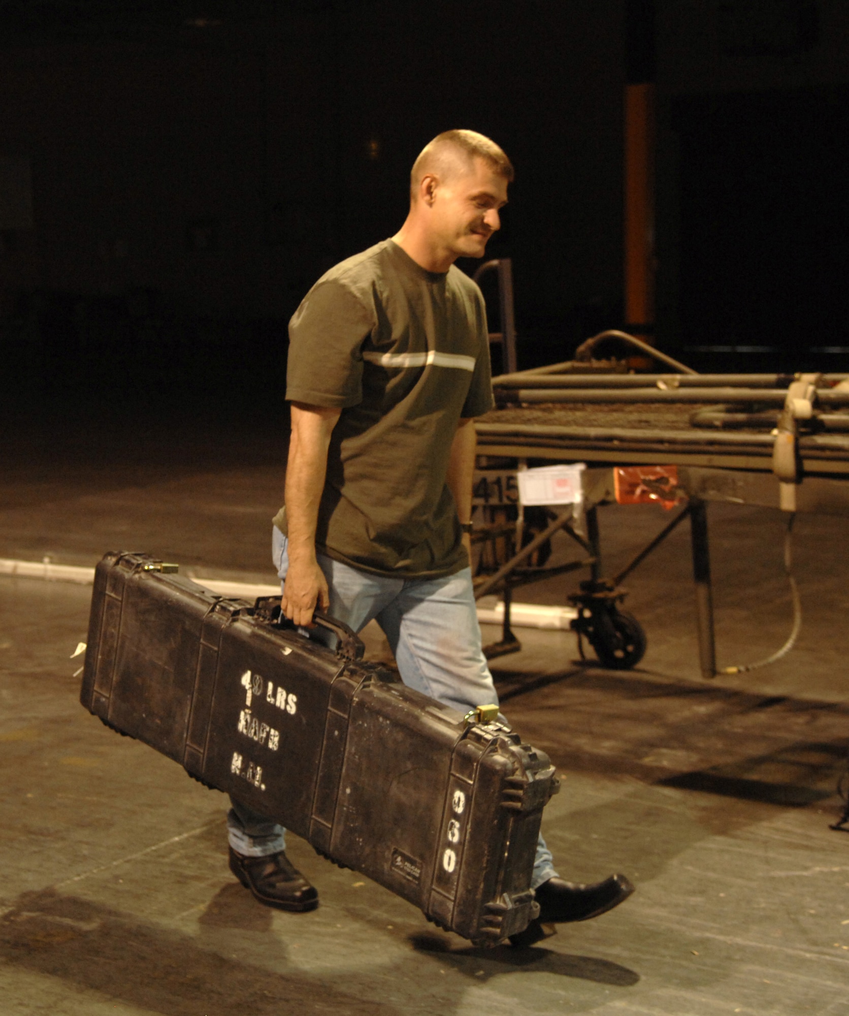 Staff Sgt. Johnnie Clevenger, 49th Materiel Maintenance Support Squadron, walks into the armory at Holloman Air Force Base, N.M., July 25, to turn in his weapon upon his return home after a deployment. Col. Michael Magee, 49th Fighter Wing vice commander and Command Chief Master Sgt. Jeffery Cui, 49th Fighter Wing command chief were a few of the many people who waited to greet the returning warriors upon their arrival. (U.S. Air Force photo/Airman Sondra M. Wieseler)