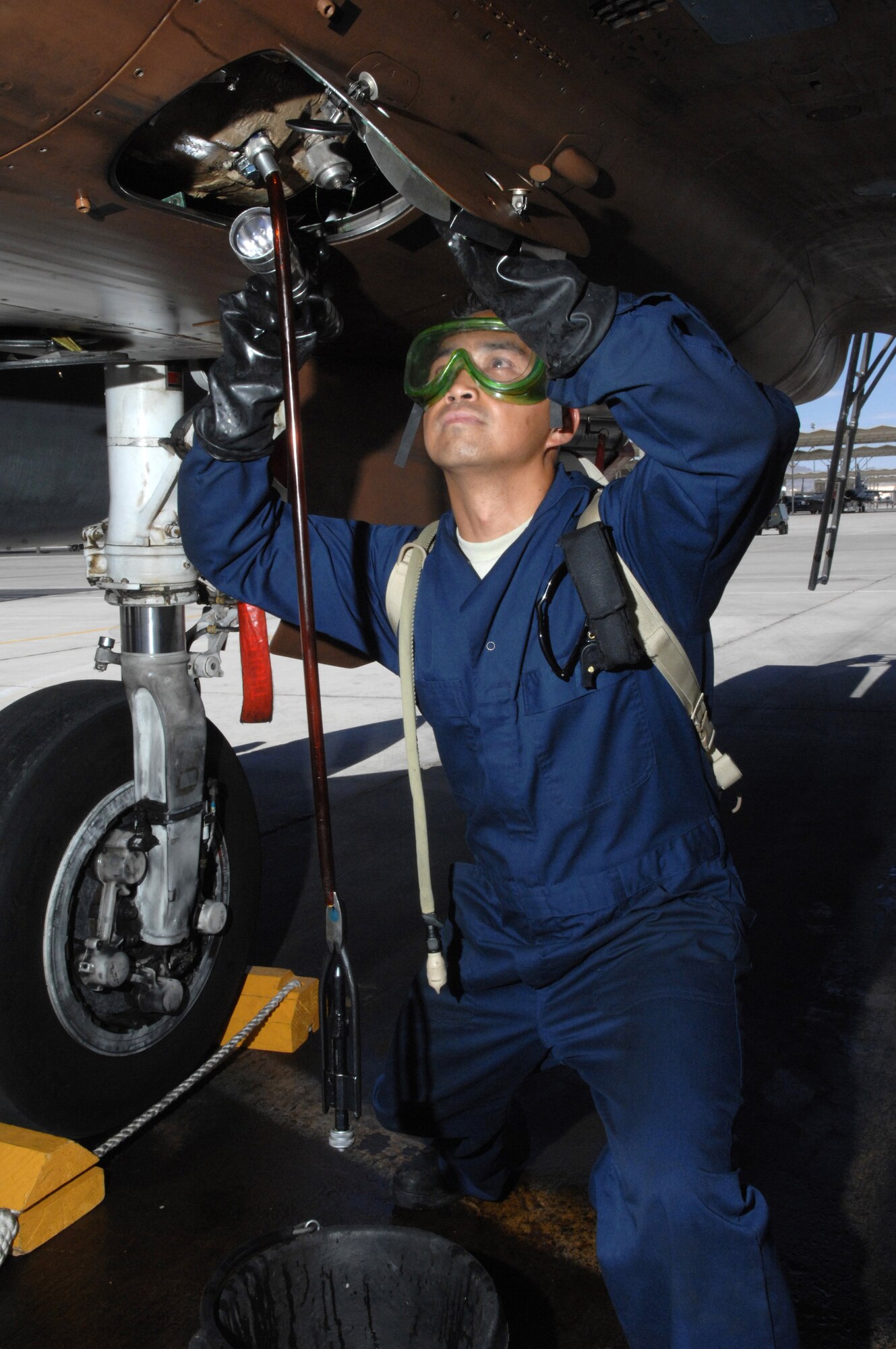 Staff Sgt. Raymond Oliveros services a generator on a F-15 Eagle July 24 at Nellis Air Force Base, Nev. The 926th Group is an Air Force Reserve unit under the 10th Air Force, Naval Air Station Joint Reserve Base, Fort Worth, Texas. The group is located at Nellis AFB as an associate unit to the Air Force Warfare Center. Through total force integration, reservists are integrated into active duty Air Force units, accomplishing the mission alongside active-duty Airmen on a daily basis. Sergeant Oliveros is an F-15 crew chief assigned to the 926th Group Det. 2. (U.S. Air Force photo/Senior Airman Larry E. Reid Jr.)
