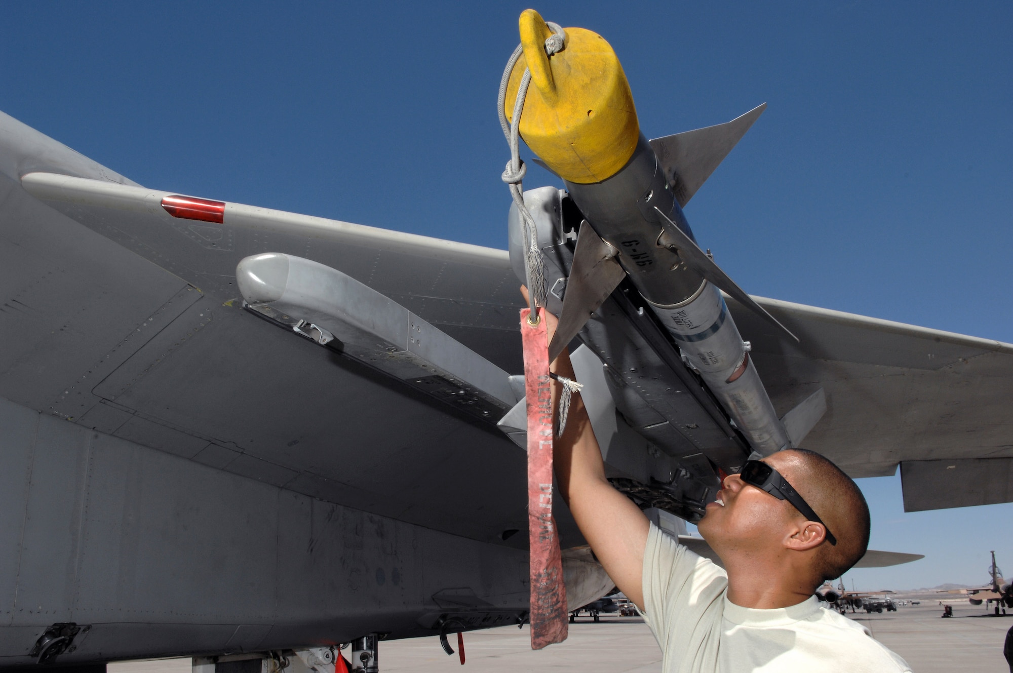 Tech. Sgt. John Robles performs a supervisory post-load inspection of an AIM-9 missile July 24 at Nellis Air Force Base, Nev. The 926th Group is an Air Force Reserve unit under the 10th Air Force, Naval Air Station Joint Reserve Base, Fort Worth, Texas. The group is located at Nellis AFB as an associate unit to the Air Force Warfare Center. Reservists are integrated into active duty Air Force units accomplishing the mission alongside active-duty Airmen on a daily basis. Sergeant Robles is an F-15 Eagle weapons expediter assigned to the 926th Group Det. 2. (U.S. Air Force photo/Senior Airman Larry E. Reid Jr.)
