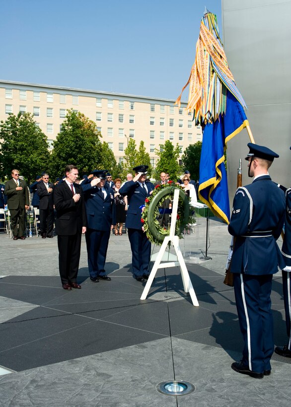 In observance of the 60th Anniversary of the Air Force Office of Special Investigations a wreath is placed at the Air Force Memorial Aug. 1. Saluting the wreath in a moment of tribute to the men and women of AFOSI are (l to r) Mr. Douglas Thomas, AFOSI Executive Director, Command Chief Master Sgt. Chris Redmond, AFOSI Command Chief and Brig. Gen. Dana Simmons, AFOSI commander. (U.S. Air Force photo/Mike Hastings)