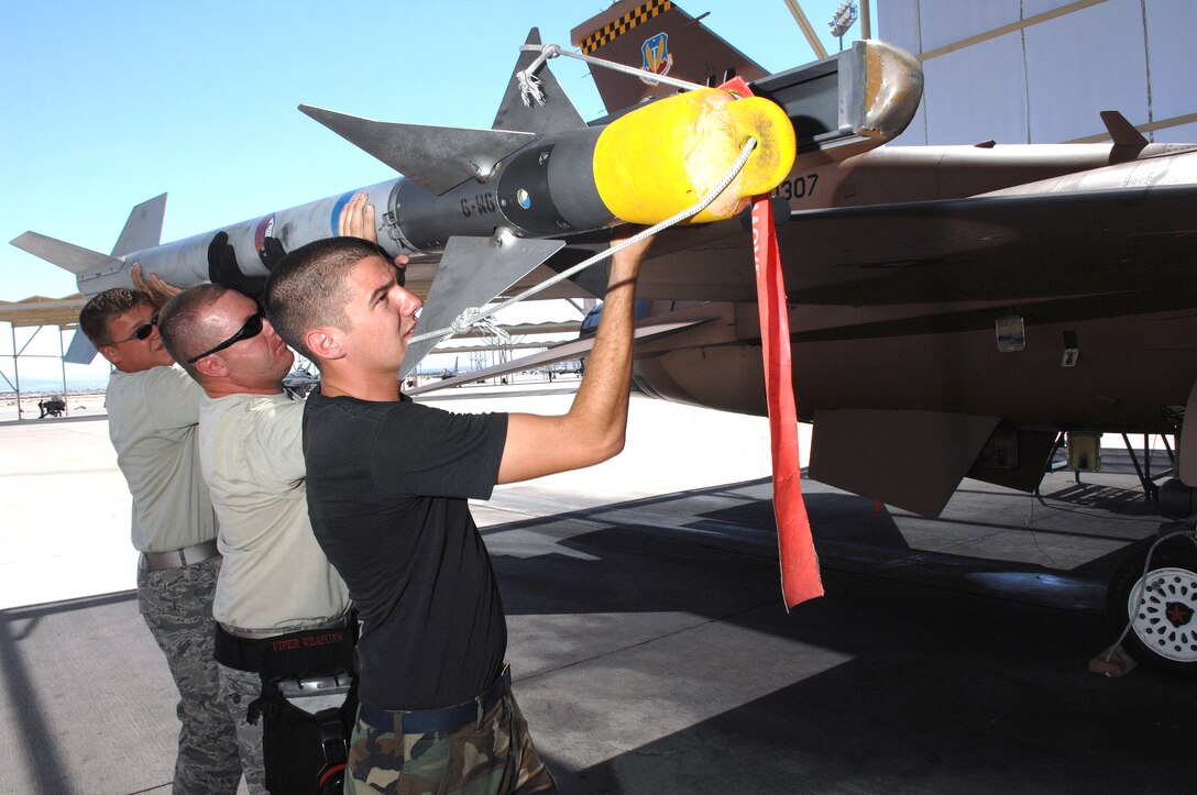 U.S. Air Force Senior Airman Gregory Strouse, left, Staff Sgt. Sean ...