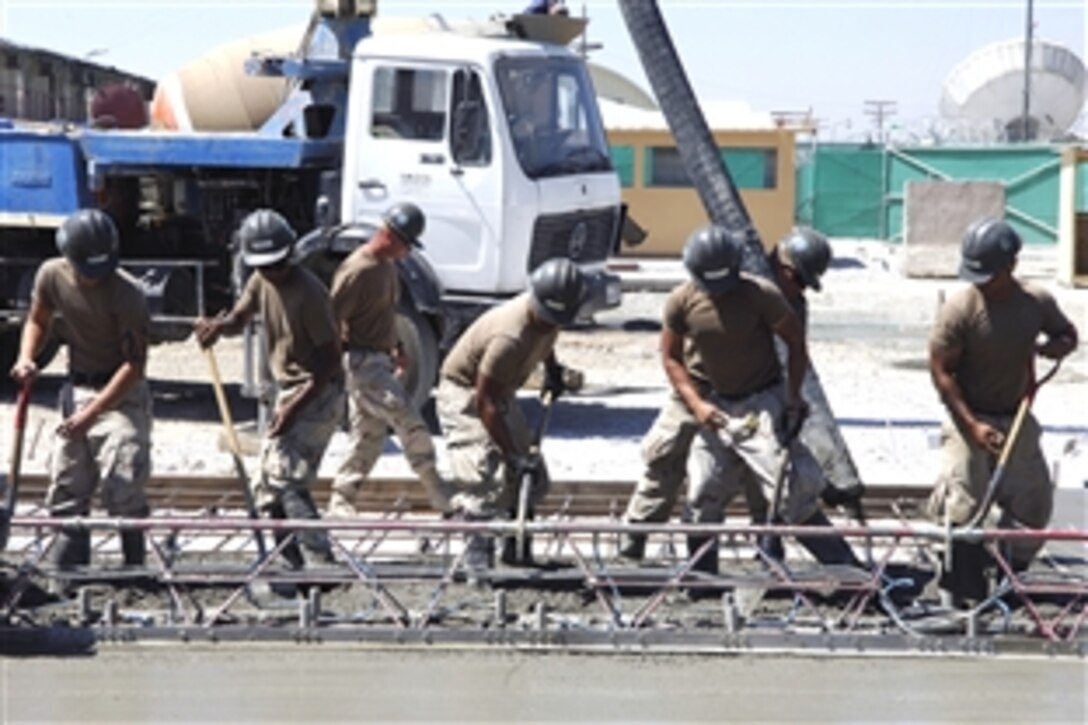 U.S. Navy Seabees lay concrete on Bagram Air Field, Afghanistan, July 24, 2008. The sailors are assigned to Detachment 4, Naval Mobile Construction Battalion 3, which is building facilities in support of the International Security Assistance Force.