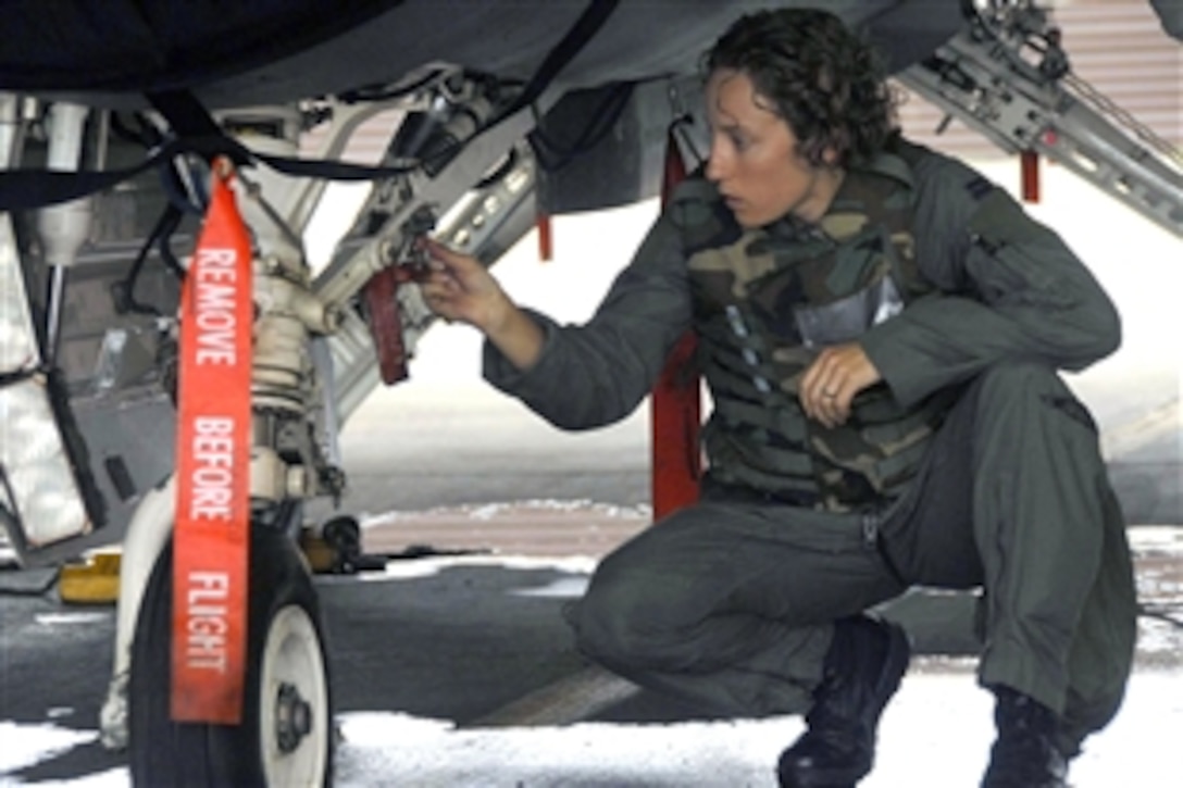 U.S. Air Force Capt. Kristin Hubbard checks the landing gear on a F-16 Fighting Falcon during a base-wide exercise on Osan Air Base, South Korea, July 21, 2008. Captain Hubbard is a pilot assigned to the 36th Fighter Squadron. The exercise tested the ability of Osan personnel to execute combat operations, receive follow-on forces and defend the base from attack. 