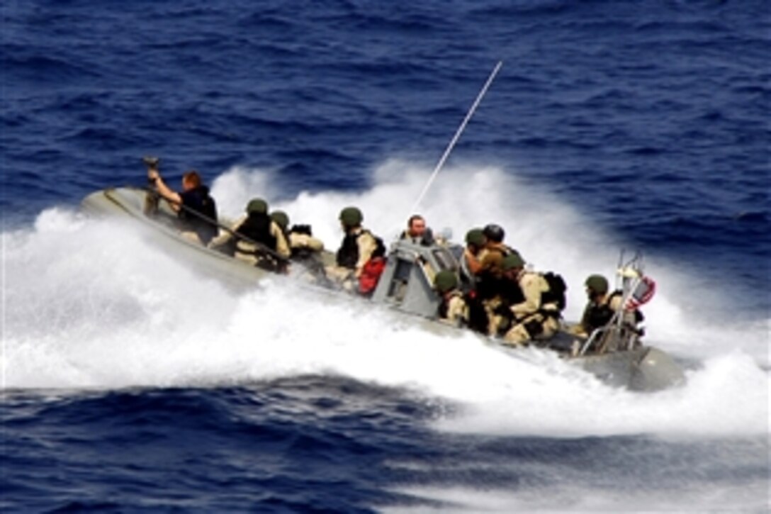 The visit, board, search, and seizure team from the guided-missile cruiser USS Vella Gulf  speeds through the water in a rigid hull inflatable boat before conducting boarding exercises in the Atlantic Ocean, July 21, 2008. Vella Gulf is participating in Joint Task Force Exercise 08-4 as a part of the Iwo Jima Expeditionary Strike Group. 