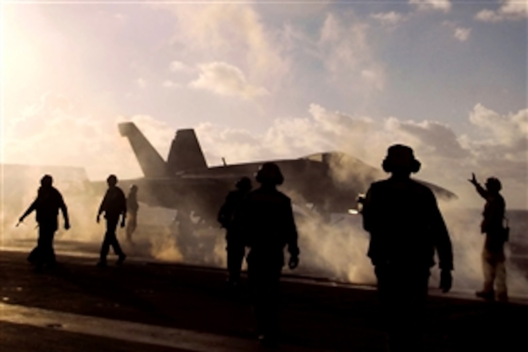U.S. sailors prepare to launch aircraft aboard the aircraft carrier USS Kitty Hawk in the Pacific Ocean, July 26, 2008, after the conclusion of Rim of the Pacific 2008, an international exercise.