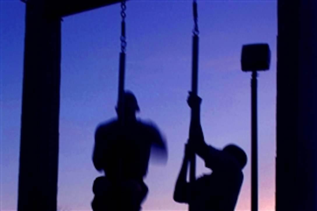 U.S. soldiers climb a rope to stay in shape during a physical fitness session on U.S. Naval Station Guantanamo Bay, Cuba, July 29, 2008. 