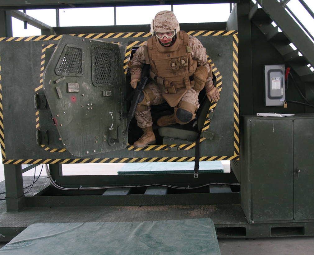 Capt. Ryan O'Connor, assistant logistics officer for 2nd Battalion, 25th Marine Regiment, leaps out of the Humvee Egress Assistance Trainer during the battalion's pre-deployment training at Mojave Viper Aug. 4, 2008.  O'Connor was an Individual Ready Reservist who mobilized to deploy to Iraq with the reserve infantry battalion.  IRR officers have an array of opportunities to mobilize in support of Marine Forces Reserve exercises and operations.