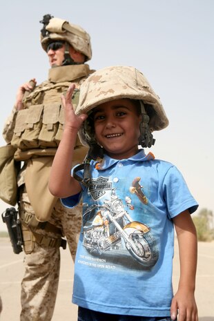 Five-year-old Ahmed spends a final few moments laughing with members of Police Transition Team 8, Regimental Combat Team 1, before leaving for Ahman, Jordan Aug. 4. Ahmed’s serious medical condition required him to visit a specialist Jordan.