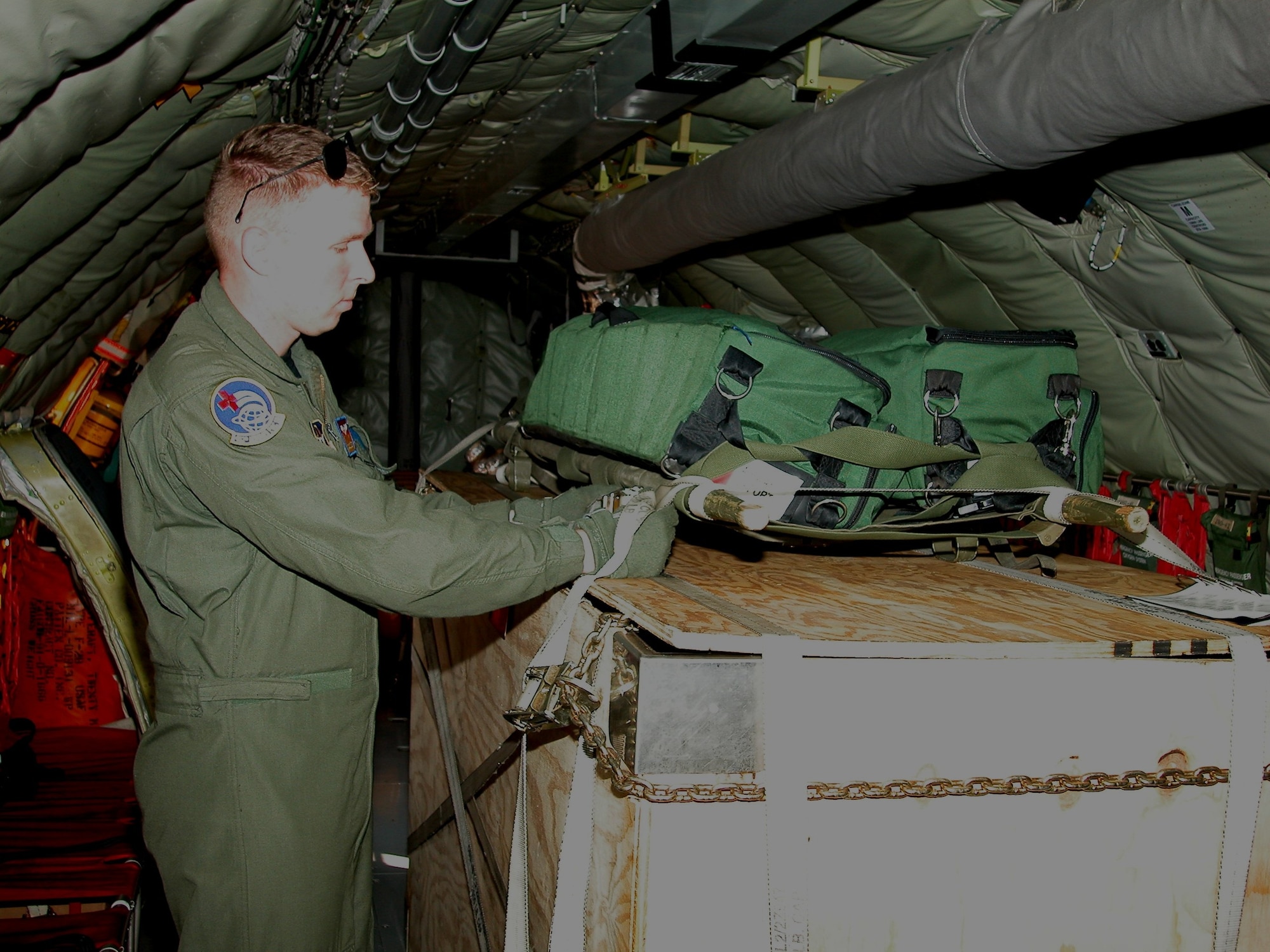 Senior Airman Ty Treece, an aeromedical evacuation technician with the 452nd AES, performs pre-flight preparations for a training mission to St. Croix, U.S. Virgin Islands.  (U.S. Air Force photo by Staff. Sgt. Joe Davidson)