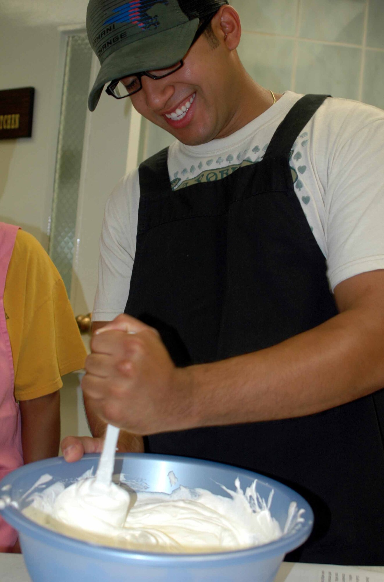 OSAN AIR BASE, Republic of Korea -- Ronald Intriago mixes Cool Whip and cream cheese together during the Just Desserts cooking class held Aug. 5 at the Airman and Family Readiness Center. The Cool Whip and cream cheese was used as frosting for the Yum Yum Strawberry Delight dessert. (U.S. Air Force photo/Staff Sgt. Candy Knight)