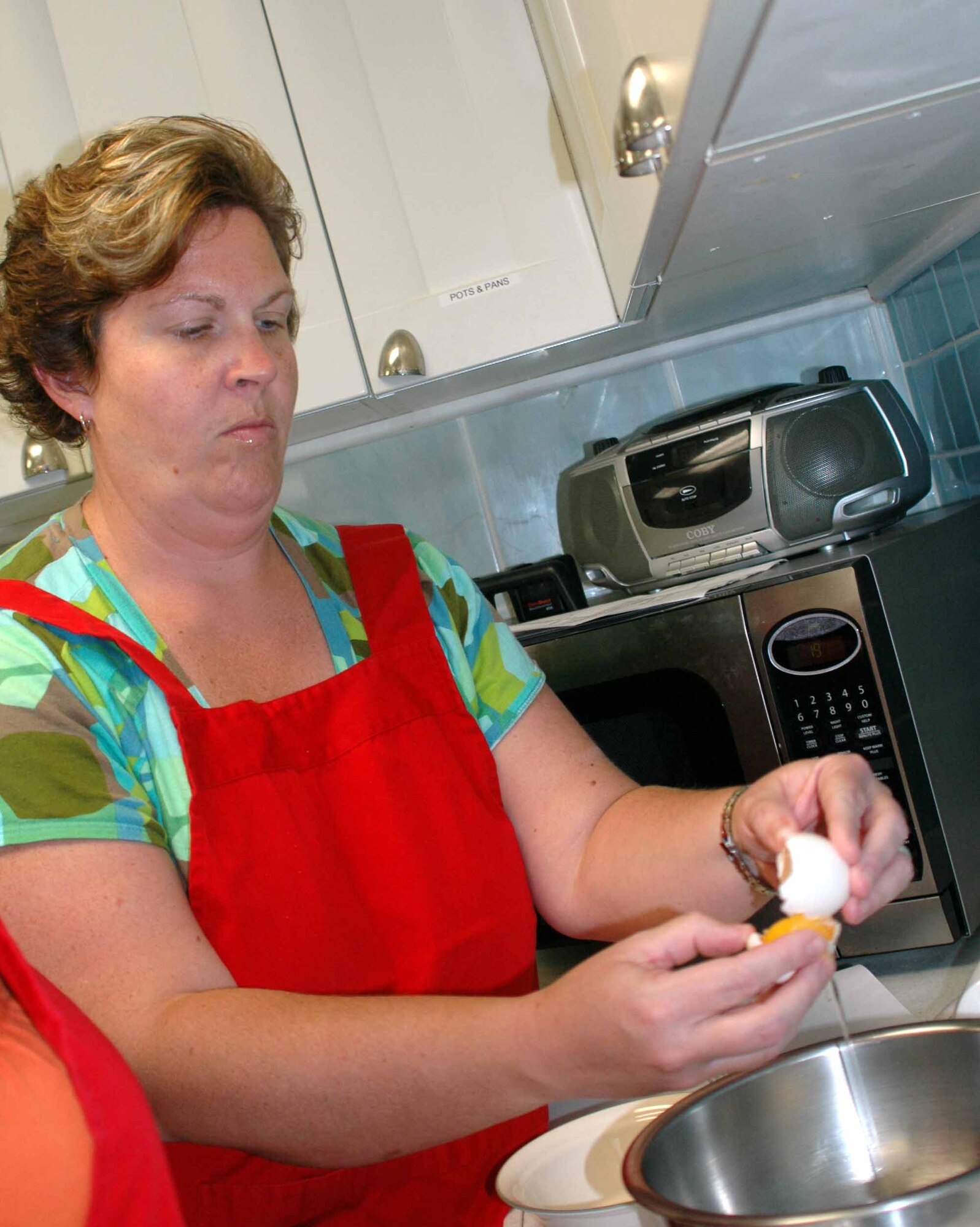 OSAN AIR BASE, Republic of Korea – Lynniece Somers carefully separates egg yolks from egg whites during the Just Desserts cooking class held Aug. 5 at the Airman and Family Readiness Center. Mrs. Somers prepared Mini Meringues during the class. The dessert cooking class is one of several cooking class hosted by the AFRC. (U.S. Air Force photo/Staff Sgt. Candy Knight)