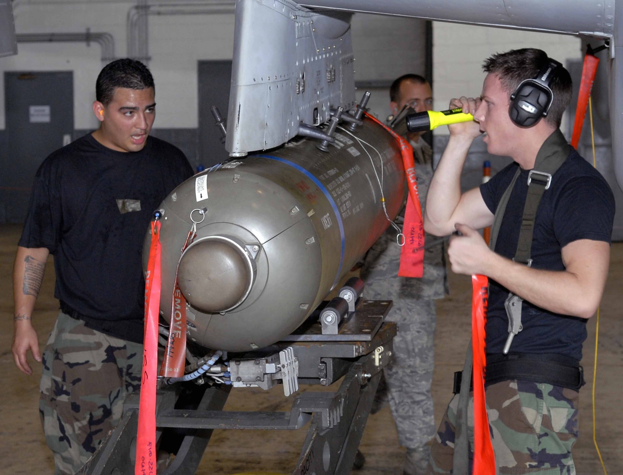 OSAN AIR BASE, Republic of Korea -- Staff Sgt. David Hink, (right), and Senior Airman Felix Rivera, check for spacing on an CBU-87 after securing it to an A-10 here Aug. 1.The two Airmen were competing against another team during a load crew of the quarter competition. Both Airmen are assigned to the 51st Aircraft Maintenance Squadron. (U.S. Air Force photo/Senior Airman Christopher Boitz)