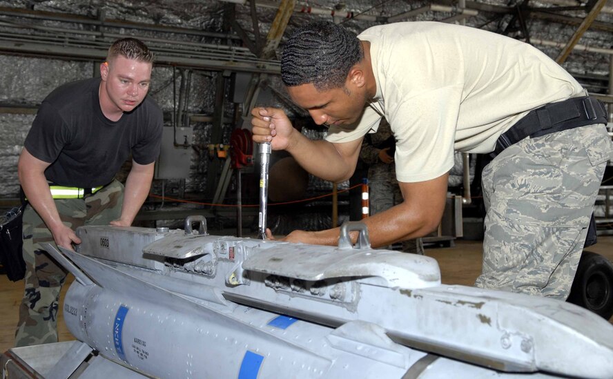 OSAN AIR BASE, Republic of Korea -- Staff Sgt. Zachary Watts, (left), and Senior Airman Van Nix, prepare an AGM-65 Maverick before securing it to an F-16 here Aug. 1. The two Airmen were competing against another team during a load crew of the quarter competition. Both Airmen are from the 51st Aircraft Maintenance Squadron. (U.S. Air Force photo/Senior Airman Christopher Boitz)