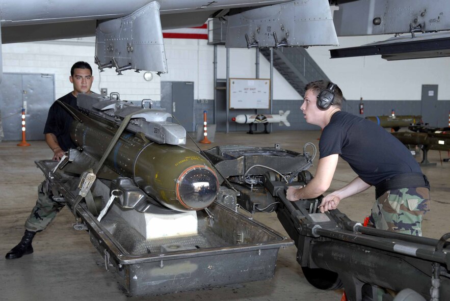 OSAN AIR BASE, Republic of Korea -- Staff Sgt. David Hink, (right), and Senior Airman Felix Rivera, load an AGM-65 Maverick to an A-10 during a load crew of the quarter competition here Aug. 1. Sergeant Hink and Airman Rivera won the competition. Both Airmen are from the 51st Aircraft Maintenance Squadron. (U.S. Air Force photo/Senior Airman Christopher Boitz)