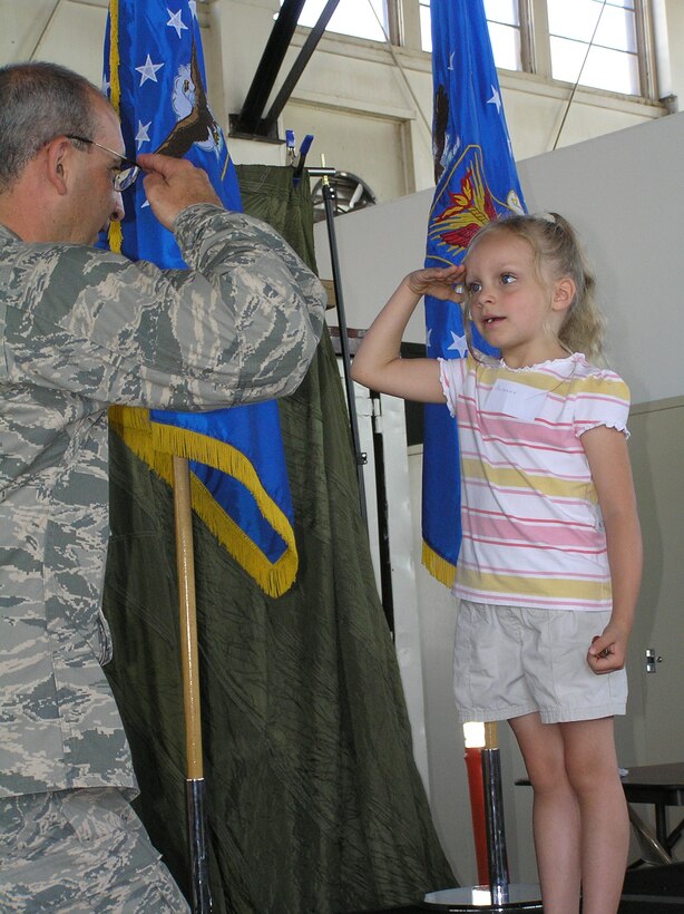 Col. James J. Muscatell, Jr., salutes Briana Taylor, daughter of TSgt. Tye Taylor, 302nd maintenance squadron, during the "Herc Adventure Tour of Duty" before the Wing's family day.  Children of Reservists were invited to experience a morning of hands-on activities showing them what their parents do while performing Reserve duty.  