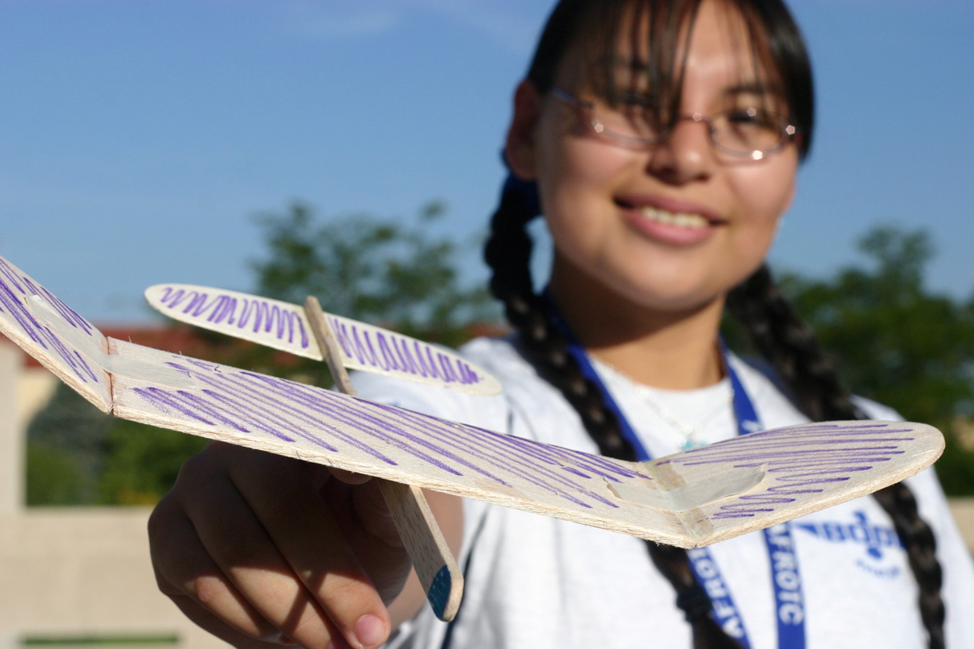 Air Force Junior ROTC Cadet Rosa Lopez from Texas shows off her team's handmade glider during the Air Force Junior ROTC Aerospace and Technology Honor Camp July 31 at Albuquerque, N.M. More than 450 cadets from Junior ROTC units worldwide participated in a total of eight camps with 54 students each - half at Albuquerque. and half at Norman, Okla., and Tinker Air Force Base. Currently, there are more than 100,000 cadets in the Air Force Junior ROTC program worldwide. (U.S. Air Force photo/Staff Sgt. Jason Lake)