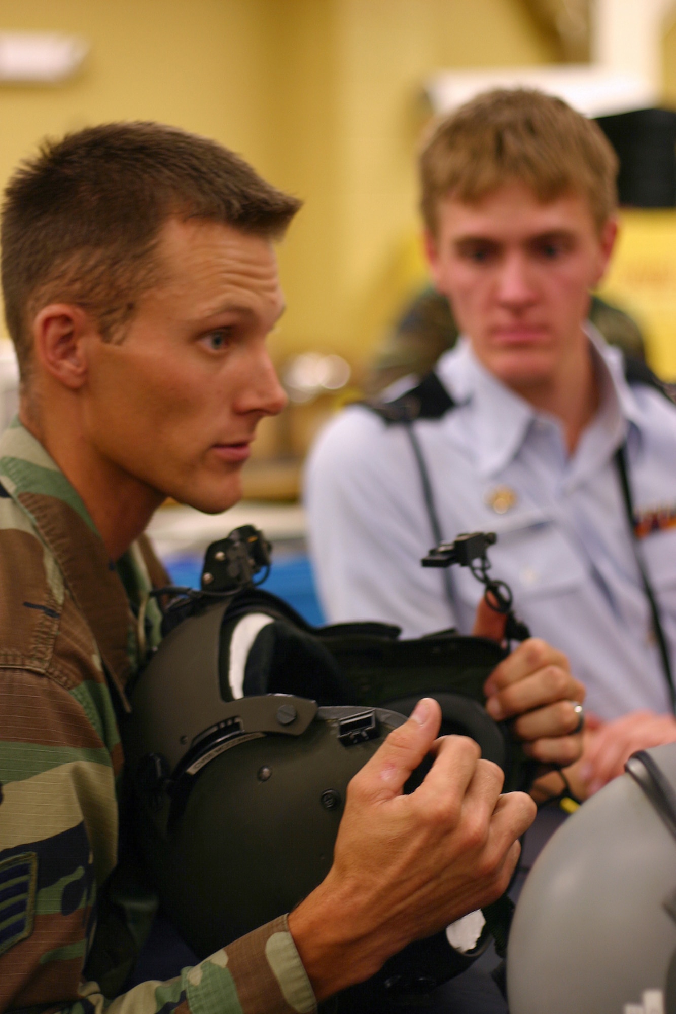 Staff Sgt. Robert Arnold talks with Junior ROTC Cadet Kyle Sanders and others about equipment used by helicopter pilots at the 58th Special Operations Wing at Kirtland Air Force Base, N.M.  More than 50 high school students from 20 states nationwide visited the squadron as part of the Air Force Junior ROTC Aerospace and Technology Honor Camps. (U.S. Air Force photo/Staff Sgt. Jason Lake)