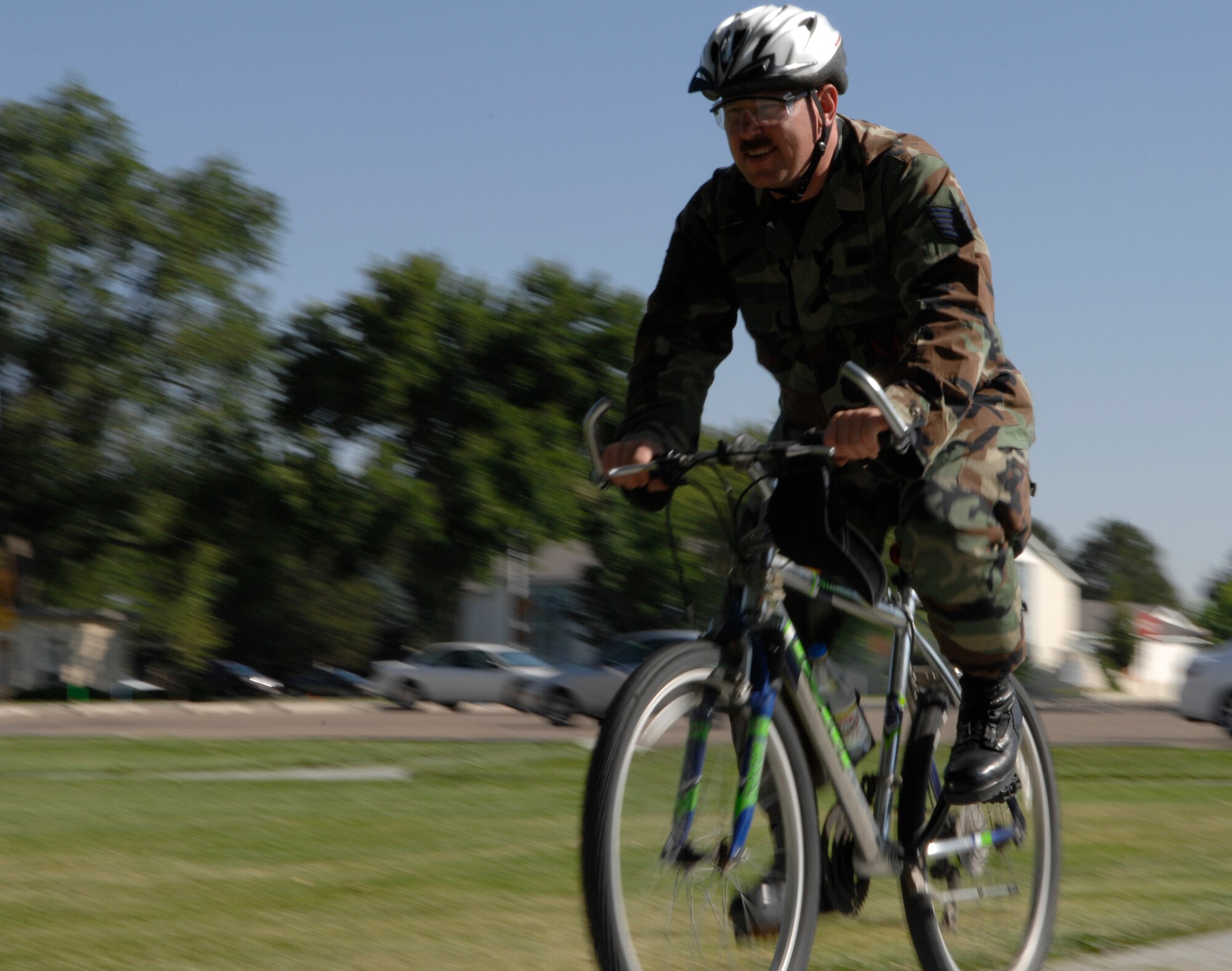 MOUNTAIN HOME AIR FORCE BASE, Idaho -- Tech. Sgt. Stephen Lusk, 366th Communications Squadron, rides his bicycle from base housing to work Aug. 5. By riding his bike instead of driving, TSgt Lusk saves money at the pump and only experiences a slight increase in his commute time. (U.S. Air Force photo by Airman First Class Ashley Winters) 