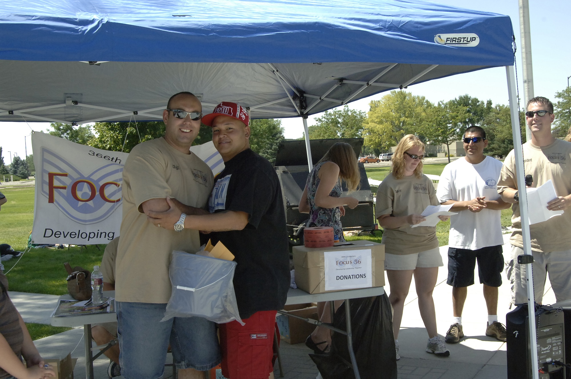 MOUNTAIN HOME AIR FORCE BASE, Idaho -- Staff Sgt. Cisco Estrada (right) poses with Tech. Sgt. Paul Tancredi, Focus 56 vice president, after taking first place in the truck category at the Focus 56 Auto Showdown Aug. 2 at Holt Park. Sergeant Estrada won with a white 2008 Ford F-150. (U.S. Air Force photo by Staff Sgt. Jasmine Reif) 
