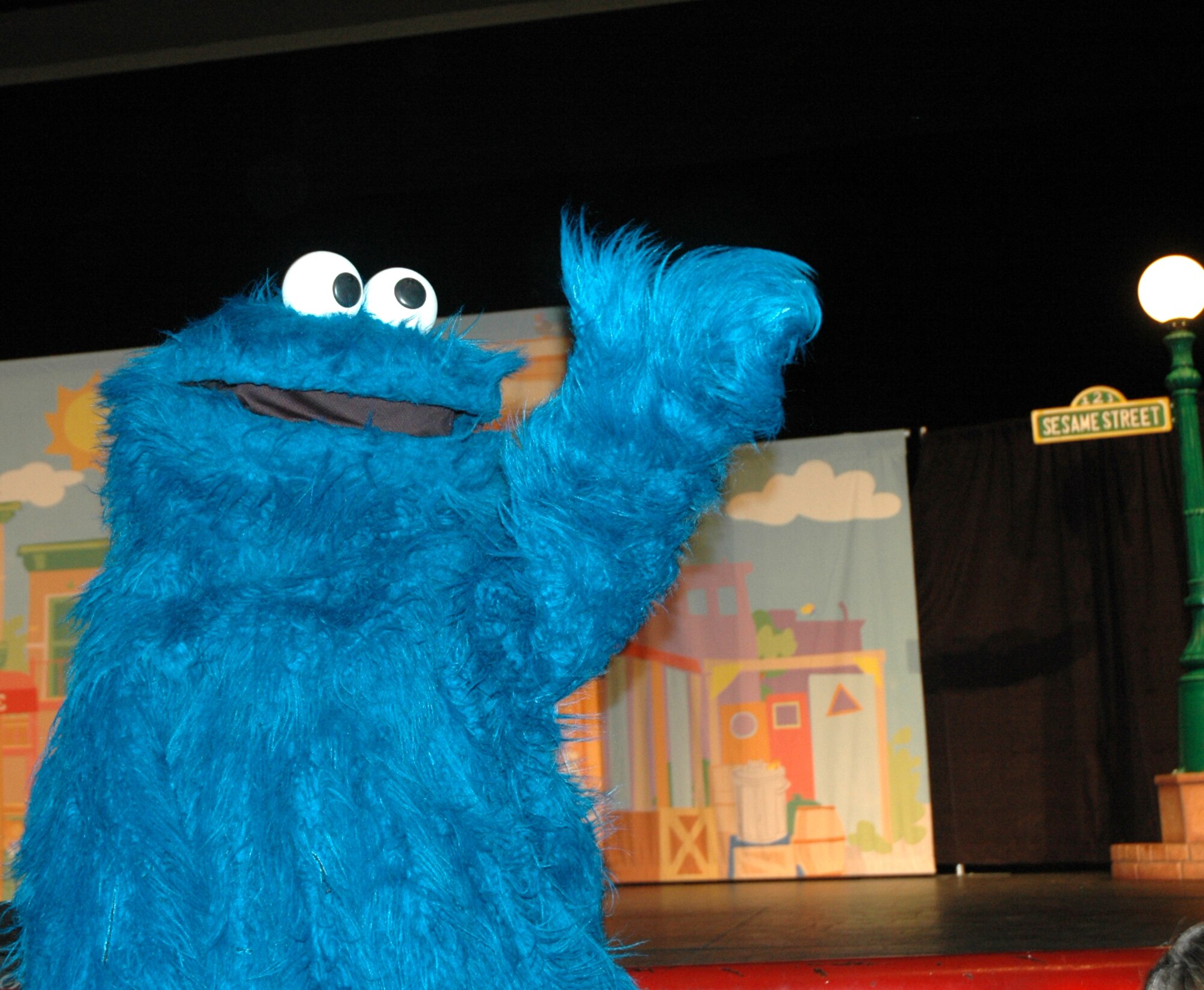 Cookie Monster waves good-bye to the children at the end of the show at North Ridge High School in Layton, August 1.  (U.S. photo by Airman 1st Class Robby Hedrick)