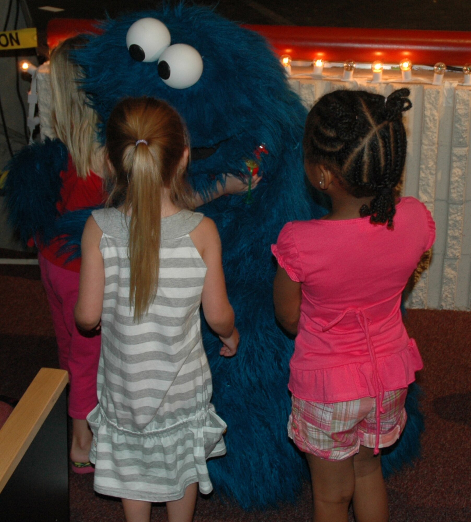 Cookie Monster takes the time to hug some children during a live performance at North Ridge High School in Layton, August 1.  (U.S. photo by Airman 1st Class Robby Hedrick)