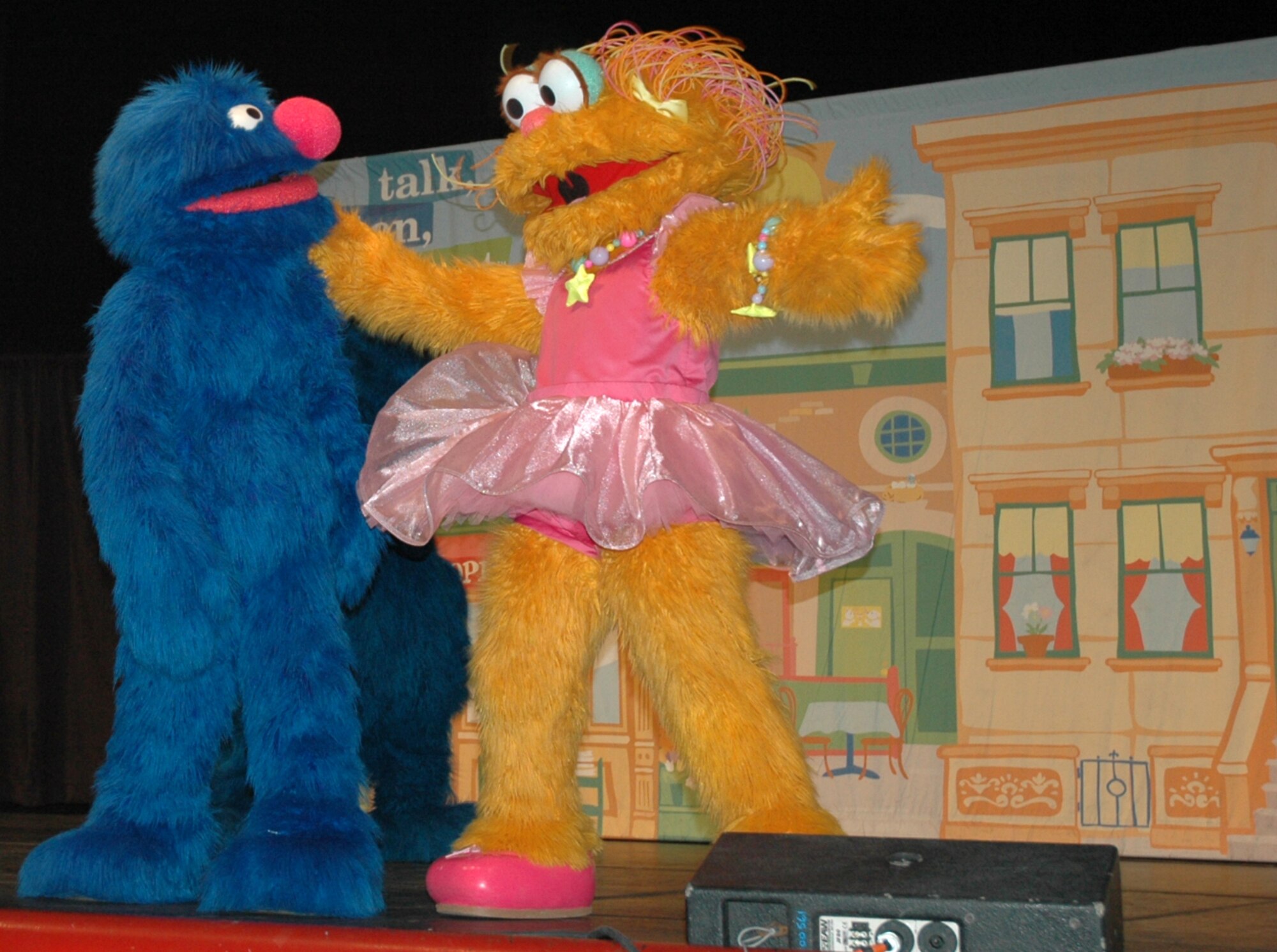 A muppet sings to Grover during the live performance at North Ridge High School in Layton, August 1.  (U.S. photo by Airman 1st Class Robby Hedrick)