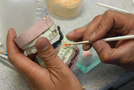 Jeffrey Paje, 12th Dental Squadron, works on a dental mold at the medical group June 3. Team Randolph's 12th Aeromedical Dental Squadron was split into two units -- the 12th Dental Squadron and the 12th Aerospace Medicine Squadron -- Aug. 6 after the Air Force's Surgeon General mandated that the dental corps get more leadership experience within their own ranks. (U.S. Air Force photo by Rich McFadden)