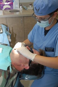 Airman 1st Class Stephanie Shump, 12th Dental Squadron, works on a dental patient at the medical group June 3. Team Randolph's 12th Aeromedical Dental Squadron was split into two units -- the 12th Dental Squadron and the 12th Aerospace Medicine Squadron -- Aug. 6 after the Air Force's Surgeon General mandated that the dental corps get more leadership experience within their own ranks. (U.S. Air Force photo by Rich McFadden)
