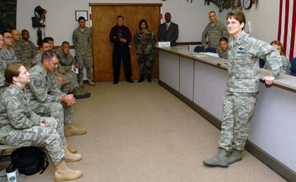 Col. Jacqueline Van Ovost, 12th Flying Training Wing commander, speaks to Airmen preparing to deploy around the globe during the last deployment line at the former deployment readiness center in Hangar 52 July 23. The DRC moved to Hangar 71 in an effort to streamline information distribution and equipment storage for servicemembers and civilians training for and deploying to support the Global War on Terror. (U.S. Air Force photo by Steve White)
