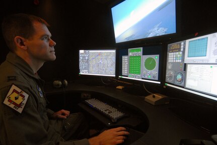 Capt. Joe Haggerty, 563rd Flying Training Squadron, tries his hand at the T-25 simulator after the ribbon cutting ceremony Aug. 1. The new simulator is state-of-the art compared to the original T-25 simulator that was built 12 years ago, updating computing power, radar systems and training scenarios. (U.S. Air Force photo by Steve White)
