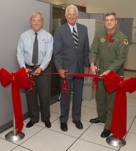 Retired Cols. Ed Larsen (left) and Mike Gilroy help Lt. Col. Chris Wellborn, 563rd Flying Training Squadron commander, dedicate the new-and-improved T-25 Simulated Electronic Combat Training Unit Aug. 1. The new simulator is state-of-the art compared to the original T-25 simulator that was built 12 years ago, updating computing power, radar systems and training scenarios. (U.S. Air Force photo by Steve White)