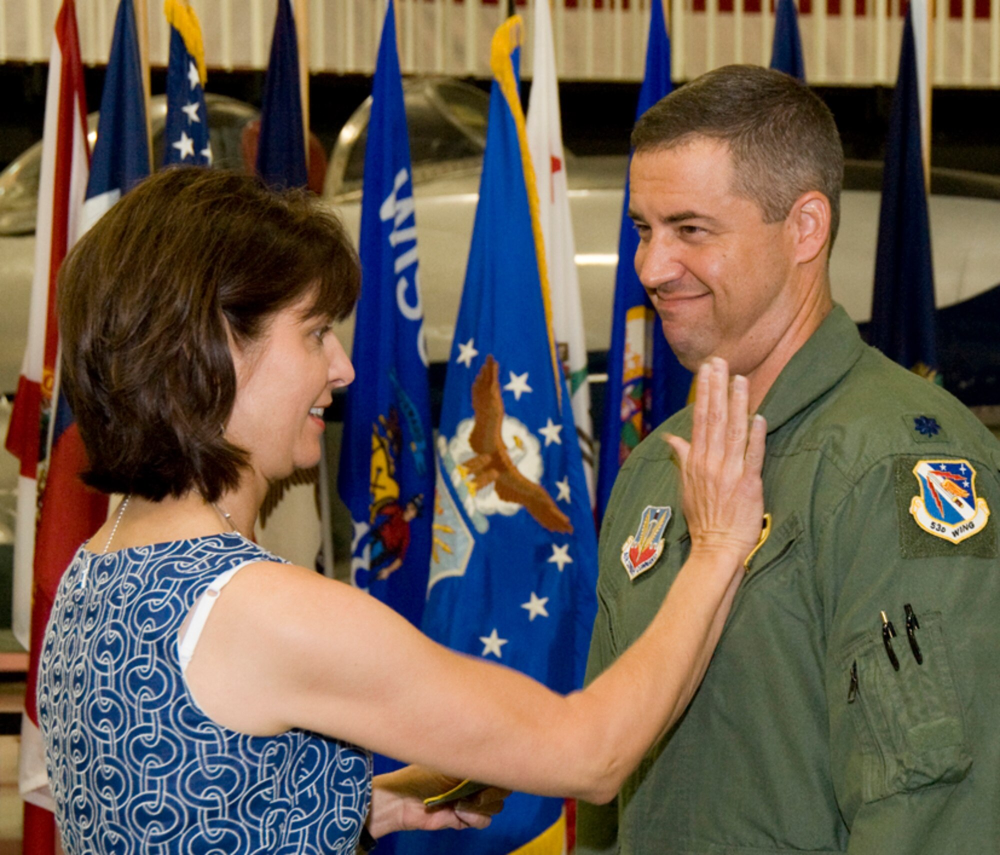 Lt. Col. Hank Jenkins receives his new patch from his wife, Mary, during the 29th Test Systems Squadron change of command ceremony July 29 at Eglin Air Force Base, Fla. Colonel Jenkins leaves his position as director of operations with the 28th Test and Evaluation Squadron to take command. U.S. Air Force photo. 