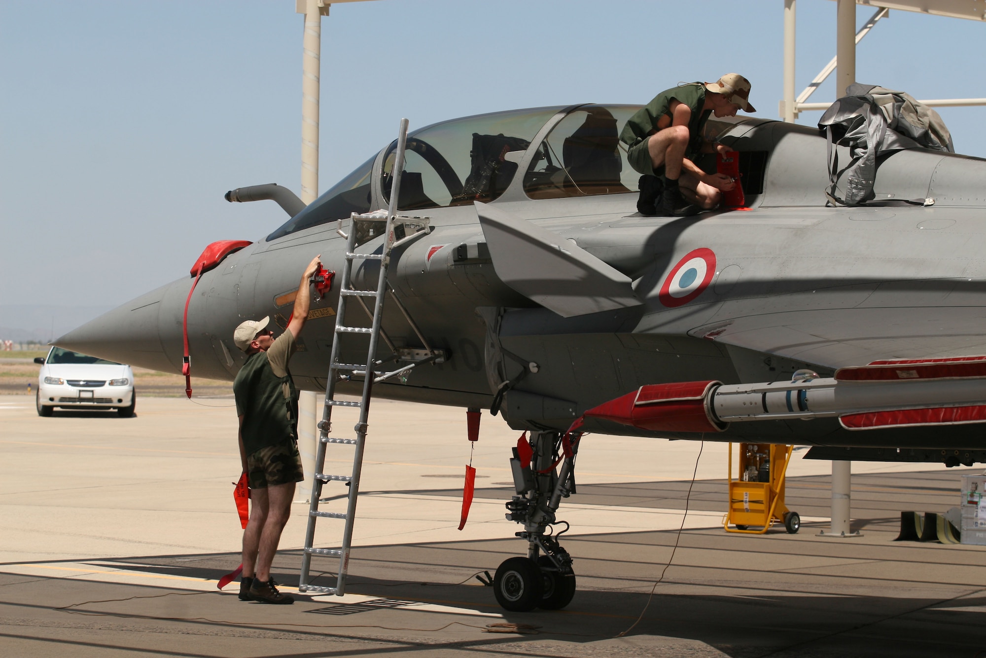 Two French air force maintainers work on their Rafale aircraft during visit to Luke AFB, July 29. Four aircraft and more than 100 personnel deployed for the first time on U.S. soil to participate in a joint exercise at Luke. (Photo courtesy of Pete Pallagi/Daily News-Sun)