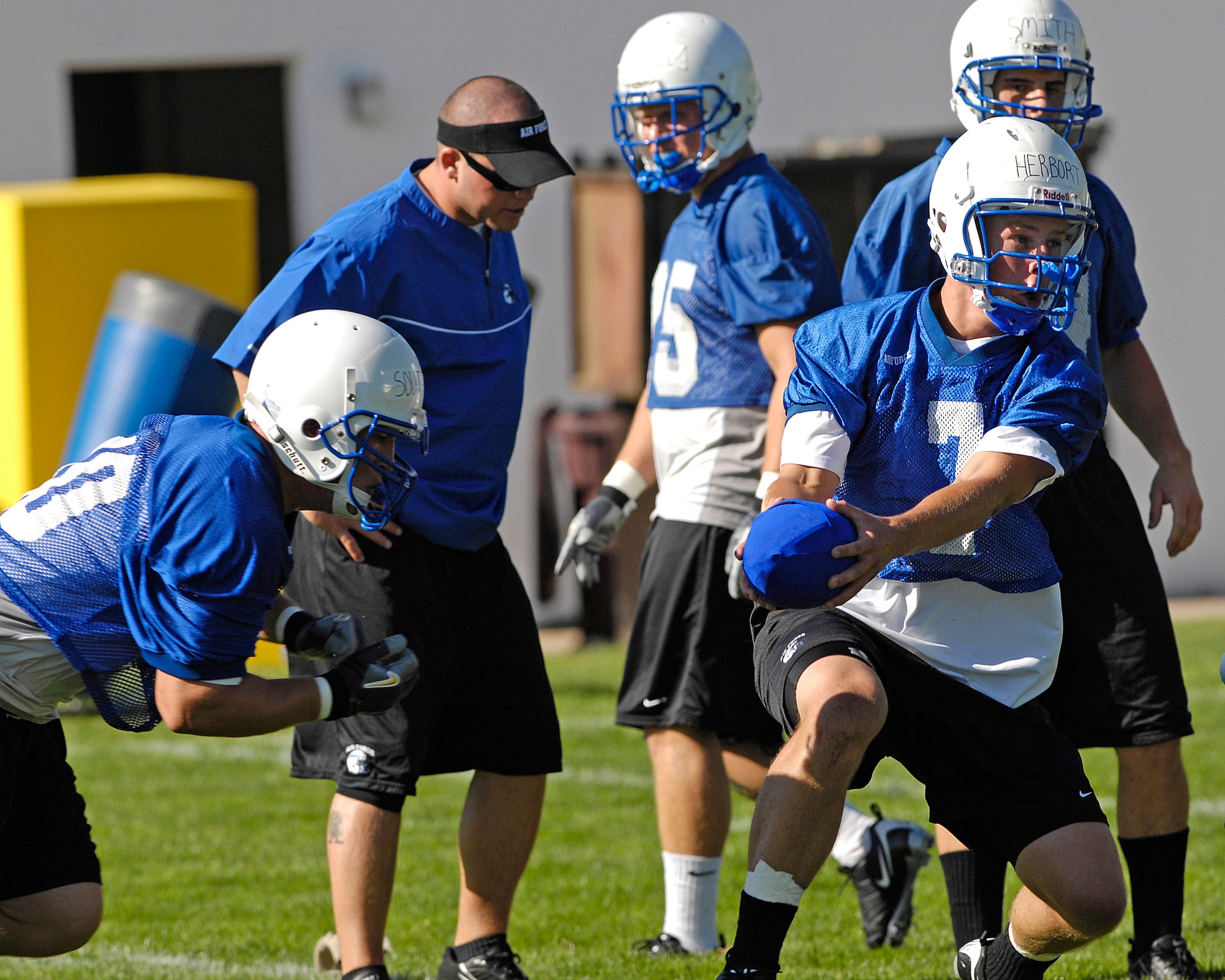 Quarterback Cadet 2nd Class Eric Herbort practices handoffs with fullback Cadet 3rd Class Ryan Southworth as the Falcons practice in preseason camp July 31 at the U.S. Air Force Academy in Colorado. (U.S. Air Force photo/Mike Kaplan)
