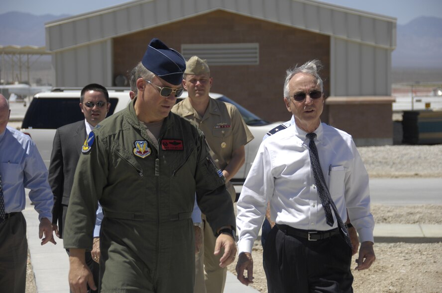 CREECH AFB, Nev. -- Deputy Secretary of Defense Gordon England tours the 432d Wing, 432d Air Expeditionary Wing with Col. Chris Chambliss, 432 WG, 432 AEW commander during a visit to Creech Air Force Base, Nev. July 31.  During his visit Sec. England visited the Unmanned Aircraft Systems Formal Training Units and operational flying squadrons.  The 432 WG is the U.S. Air Force’s first UAS wing and is equipped with more than 100 MQ-1 Predator and MQ-9 Reaper unmanned aircraft.  The wing trains pilots, sensor operators, and other UAS crewmembers, and conducts combat surveillance and attack operations worldwide. (U.S. Air Force photo/Staff Sgt. Kenneth Kennemer) 