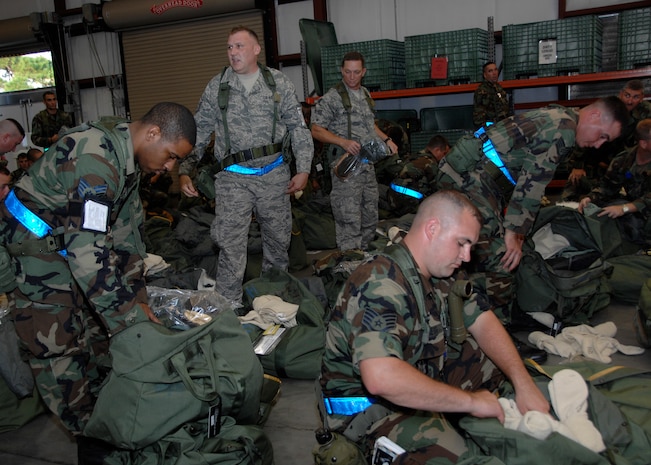 Team Charleston Airmen inspect their mobility bags at the personnel deployment facility during the Headquarters Air Mobility Command Operational Readiness Inspection Aug. 4.  Headquarters inspectors are evaluating the 437th and 315th Airlift Wings' capability to generate aircraft, deploy Airmen and cargo and employ from a forward location in support of global military operations. (U.S. Air Force photo/Airman 1st Class Katie Gieratz)