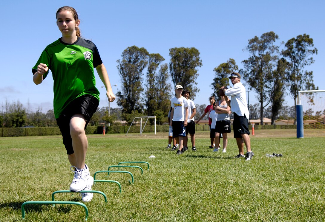 VANDENBERG AIR FORCE BASE, Calif. --  Ryan Mole, back right, running back for Cal Poly State University in San Luis Obispo, Calif., does drills and exercises with children from the Youth Center on July 30.(U.S. Air Force photo/Airman 1st Class Jonathan Olds)

