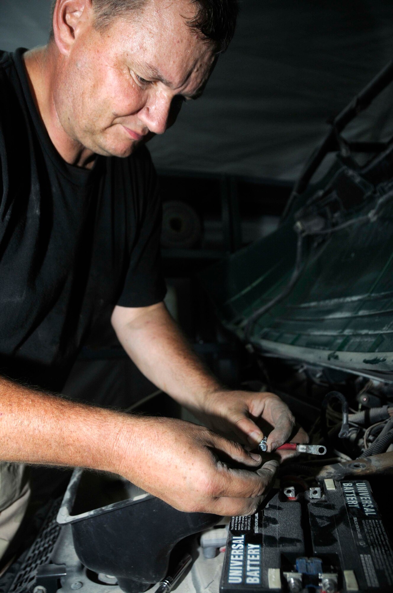 Master Sgt. Jens Walle, the noncommissioned officer in charge of barrier maintenance for the 379th Expeditionary Civil Engineer Squadron, disconnects the battery from a Polaris Ranger Aug. 4, 2008, at an undisclosed location in Southwest Asia. Sergeant Walle, a native of Charleston, S.C., is deployed from Charleston Air Force Base, S.C., in support of Operations Iraqi Freedom and Enduring Freedom. (U.S. Air Force photo by Staff Sgt. Darnell T. Cannady/RELEASED)