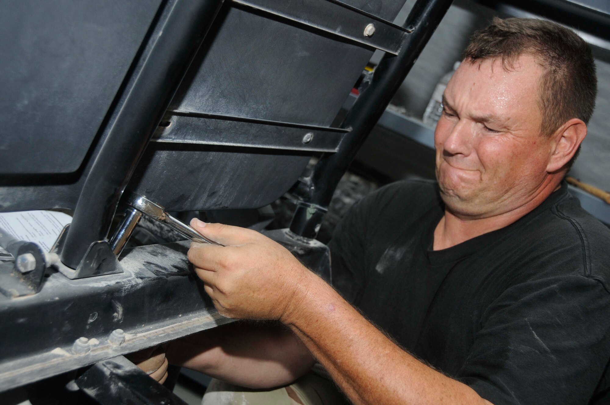 Master Sgt. Jens Walle, the noncommissioned officer in charge of barrier maintenance for the 379th Expeditionary Civil Engineer Squadron, uses a socket to remove screws from a Polaris Ranger Aug. 4, 2008, at an undisclosed location in Southwest Asia. Sergeant Walle, a native of Charleston, S.C., is deployed from Charleston Air Force Base, S.C., in support of Operations Iraqi Freedom and Enduring Freedom. (U.S. Air Force photo by Staff Sgt. Darnell T. Cannady/RELEASED)