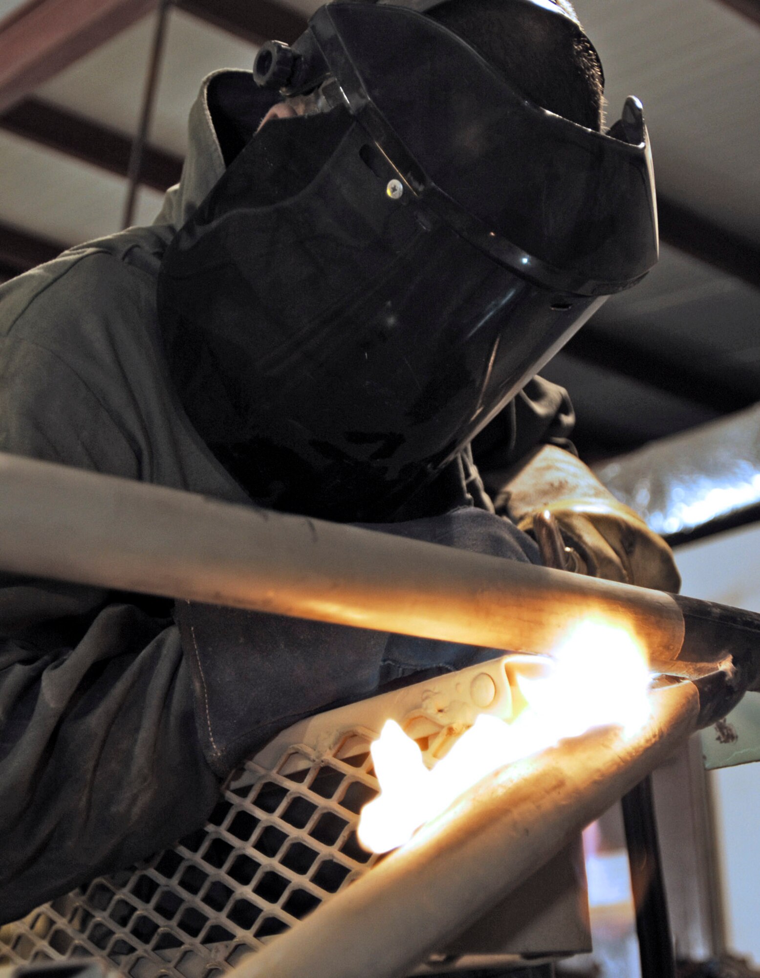Senior Airman Joseph Krafchak uses an acetylene torch to repair an aircraft maintenance stand Aug. 2 at Joint Base Balad, Iraq. Aircraft maintainers use the stands to perform maintenance on F-16s. Airman Krafshak, a metals technician journeyman with the 332nd Expeditionary Maintenance Squadron here, is deployed from Shaw Air Force Base, S.C. His hometown is Lompoc, Calif. (U.S. Air Force photo/Airman 1st Class Jason Epley) 

