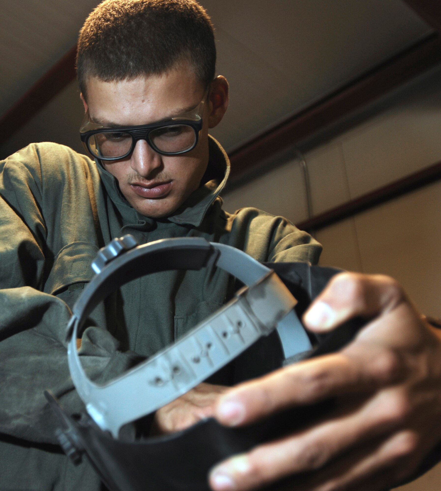 Senior Airman Joseph Krafchak turns on a welding helmet before repairing an aircraft maintenance stand Aug. 2 at Joint Base Balad, Iraq. The helmet protects the user's eyes automatically in response to the bright light emitted from welding. Airman Krafshak, a metals technician journeyman with the 332nd Expeditionary Maintenance Squadron here, is deployed from Shaw Air Force Base, S.C. His hometown is Lompoc, Calif. (U.S. Air Force photo/Airman 1st Class Jason Epley) 
