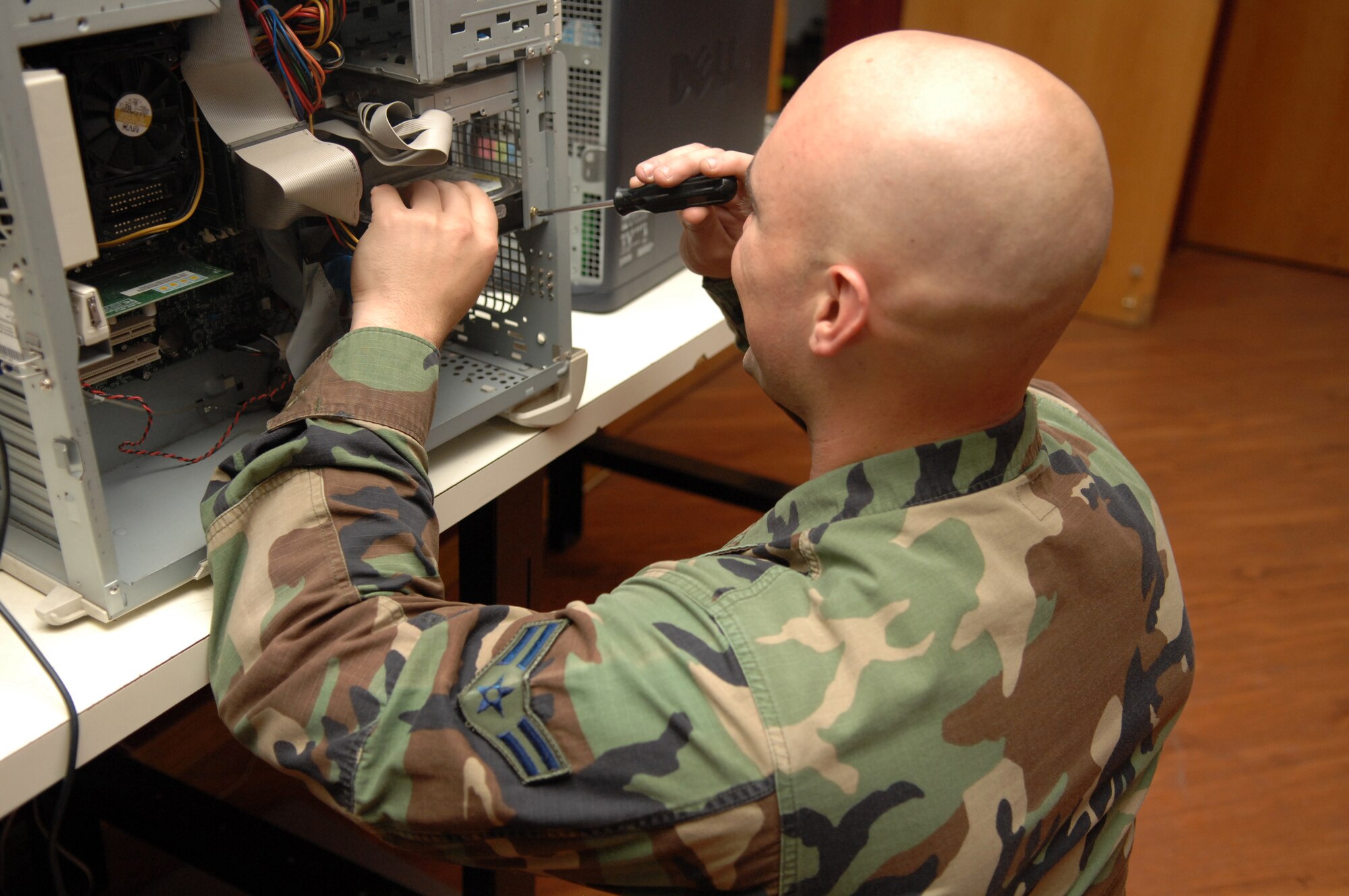 Airman 1st Class Zachary Shook, 49th Maintenance Squadron, installs a hard drive into a computer at Holloman Air Force Base, N.M., July 31. Airman Shook is a member of the 49th Maintenance Group Small Computers Shop and along with replacing hard drives, they also set up, repair and maintain government computers as well as ensure they are compliant with Air Combat Command requirements. (U.S. Air Force photo/Airman Sondra M. Wieseler)