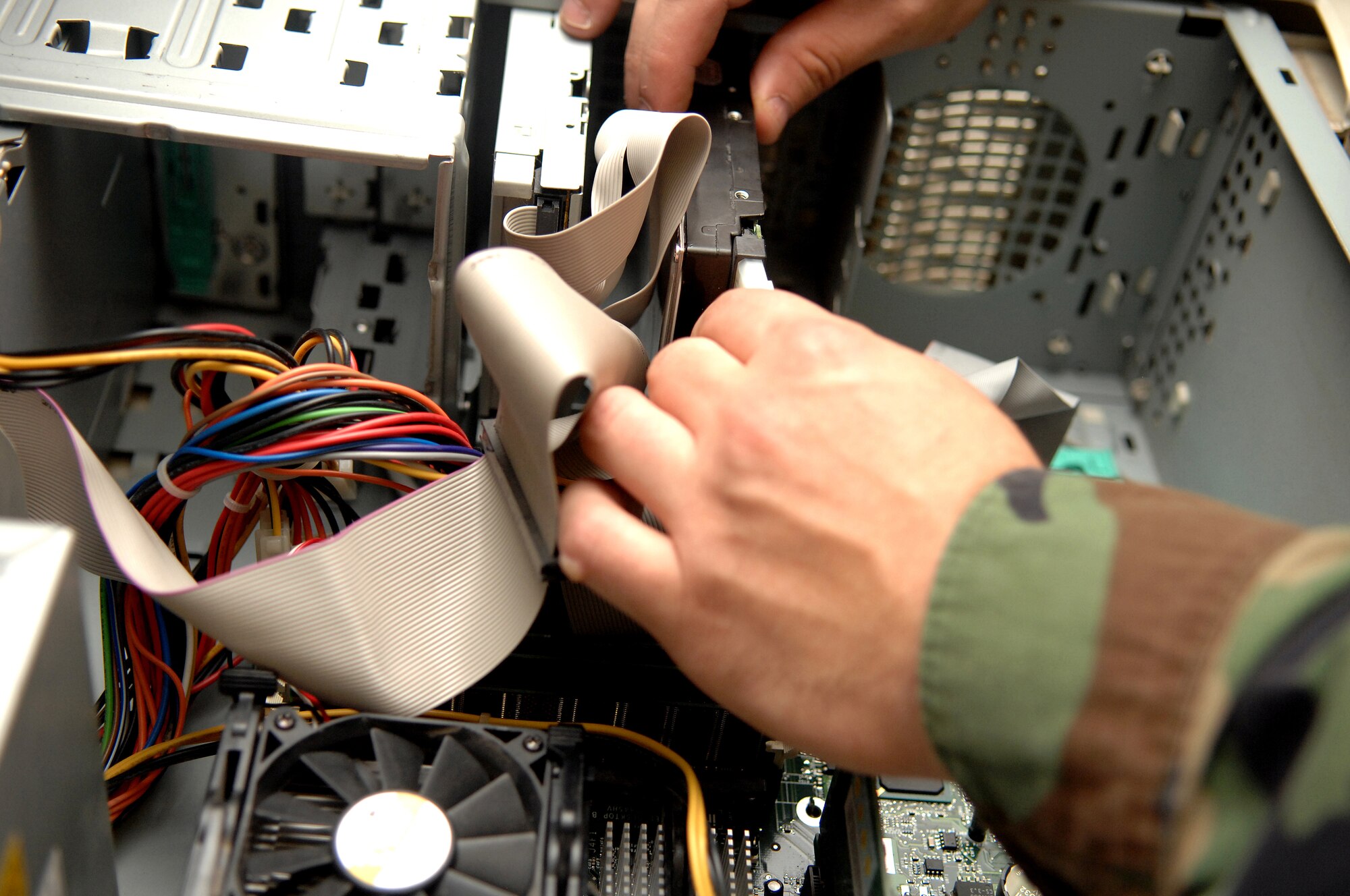 Airman 1st Class Zachary Shook, 49th Maintenance Squadron, installs a hard drive into a computer at Holloman Air Force Base, N.M., July 31. Airman Shook is a member of the 49th Maintenance Group Small Computers Shop and a part of their mission is to replace hard drives that are corrupt or need to be updated. (U.S. Air Force photo/Airman Sondra M. Wieseler)