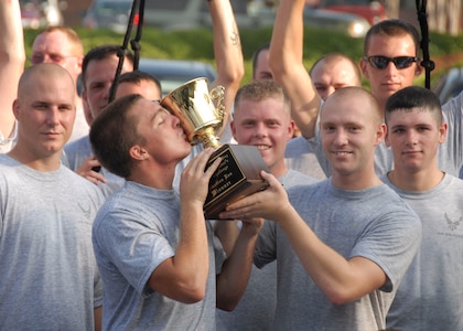 The 437th Security Forces Squadron is awarded the team spirit trophy for the commander's 5,000 meter fitness challenge Aug. 1. This month's fitness challenge was designated by the commander to motivate Airmen for the operational readiness inspection that started Aug. 3. (U.S. Air Force photo/Airman 1st Class Cynthia Spalding) 