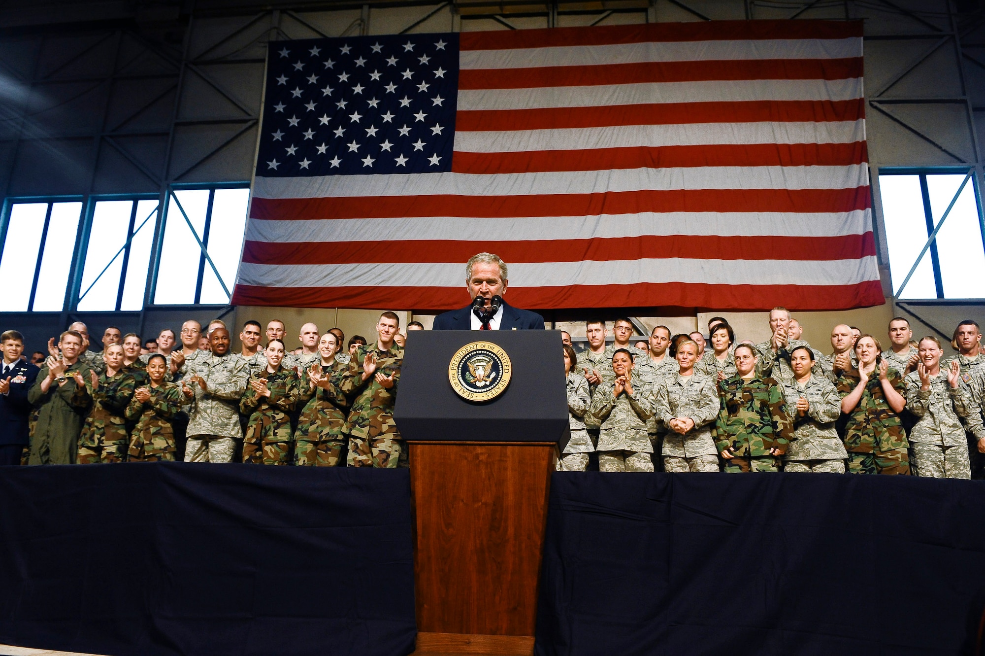 President George W. Bush gives a speech while many cheer Aug. 4 at Eielson Air Force Base, Alaska. The president made a short stop at Eielson AFB during his trip to the 2008 Olympic Games being held in Beijing. (U.S. Air Force photo/Airman 1st Class Jonathan Snyder) 
