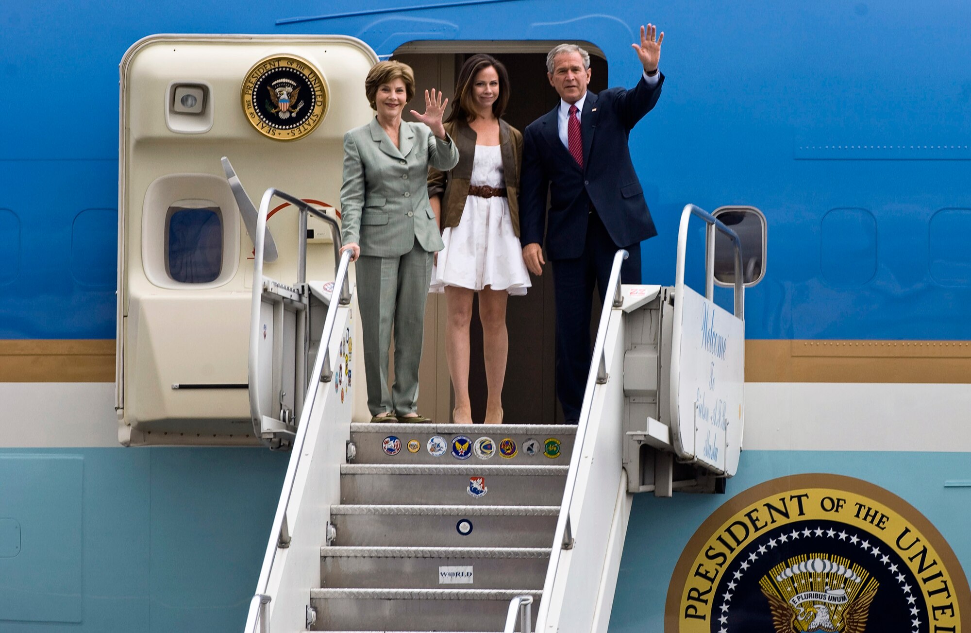President George W. Bush, First Lady Laura Bush and their daughter, Barbara Bush, wave as they exit Air Force One Aug. 4 at Eielson Air Force Base, Alaska. The president talked to a crowd of more than 2,000 military members. (U.S. Air Force photo/Airman 1st Class Jonathan Snyder) 
