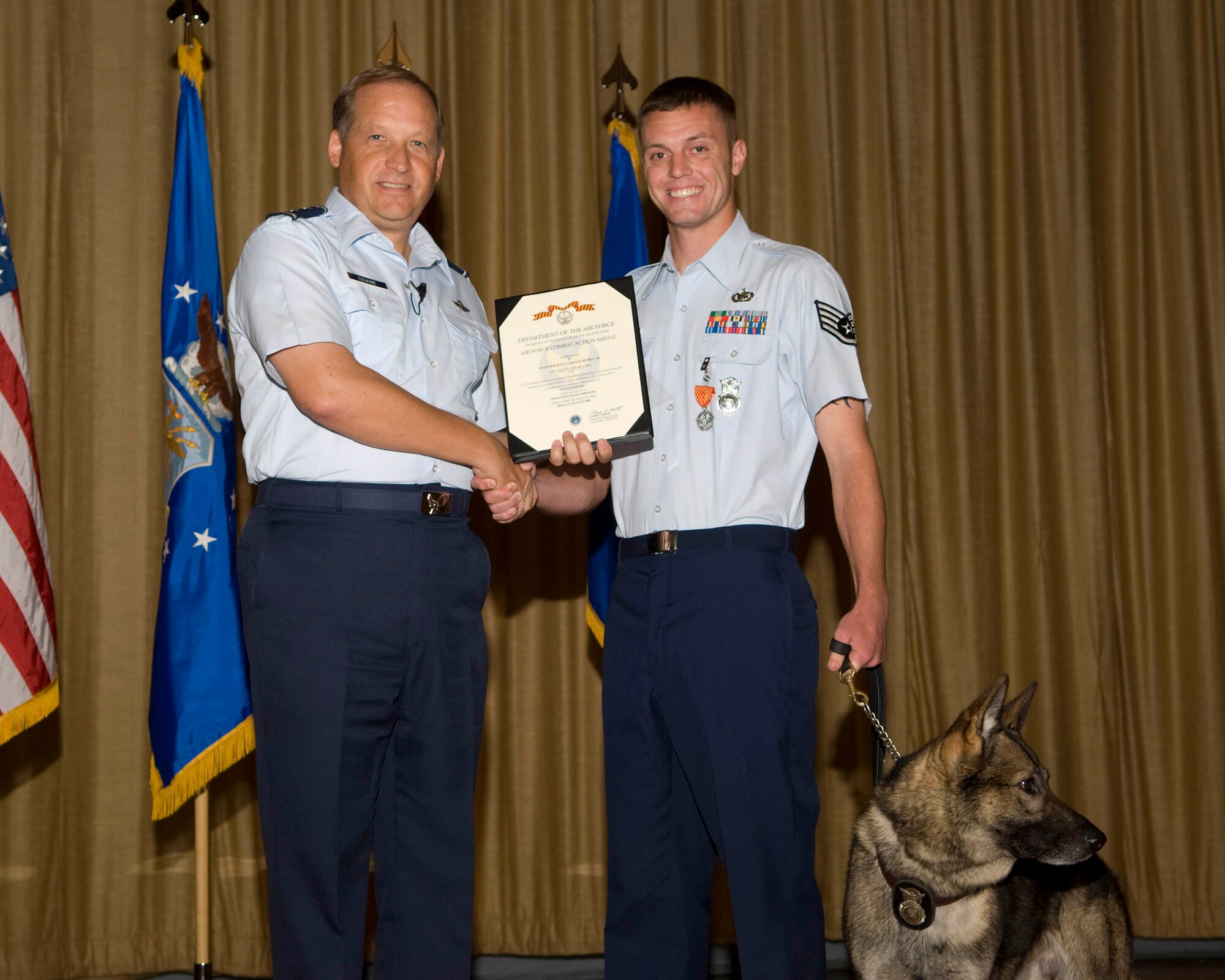 Gen. David Eidsaune presents Staff Sgt. James Richey the Combat Action Medal at the commander's call July 31, for for active participation in combat.
