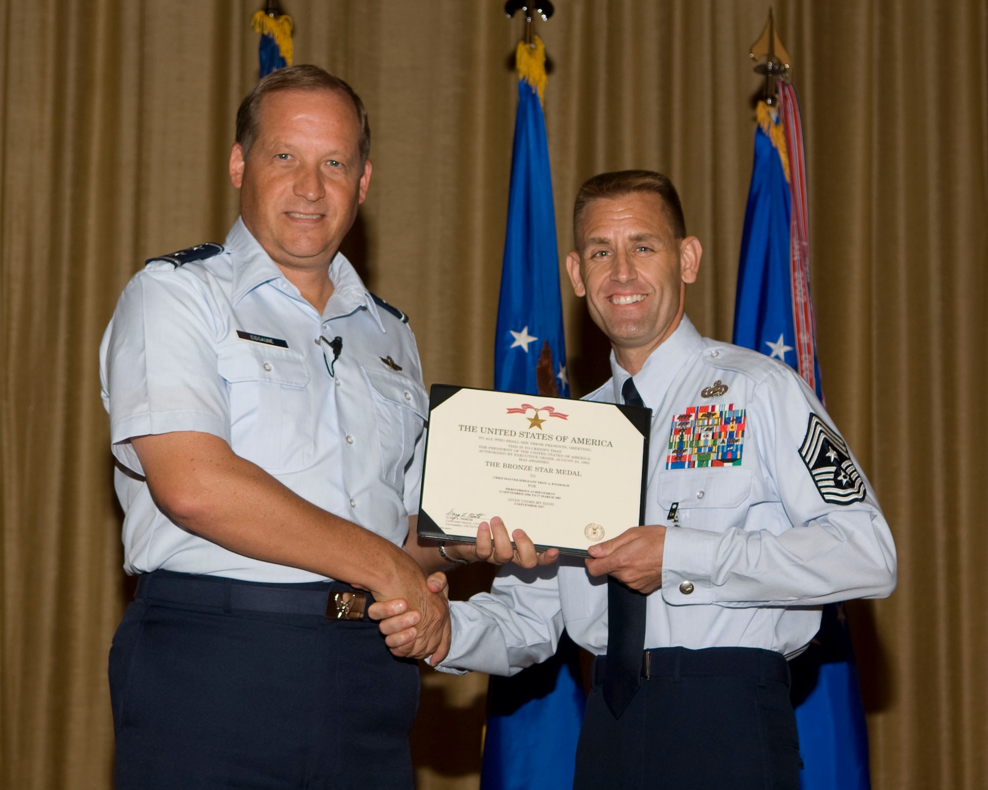 Gen. David Eidsaune presents Chief Master Sgt. Troy Engholm the Bronze Star Medal at the commander's call July 31, for meriotorious achievement while Group Superintindent, 755th Expeditionary Mission Support Group 455th Air Expeditionary Wing while engaged in ground operations at Bagram Airfield, Afghanistan,